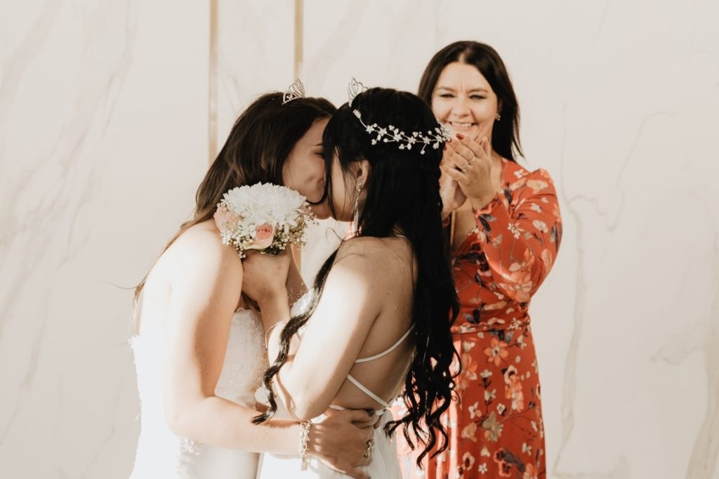 newlywed lesbian couple kissing each other