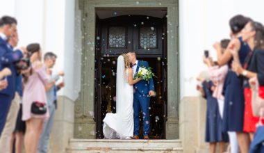 Newlyweds kissing while exiting the church