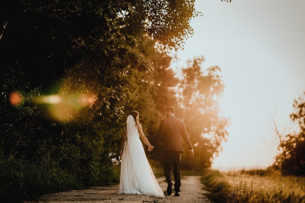 newlyweds walking on sunset