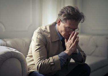 sad man sitting on a couch
