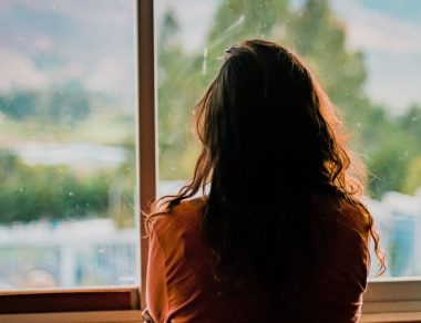 woman staring out the window
