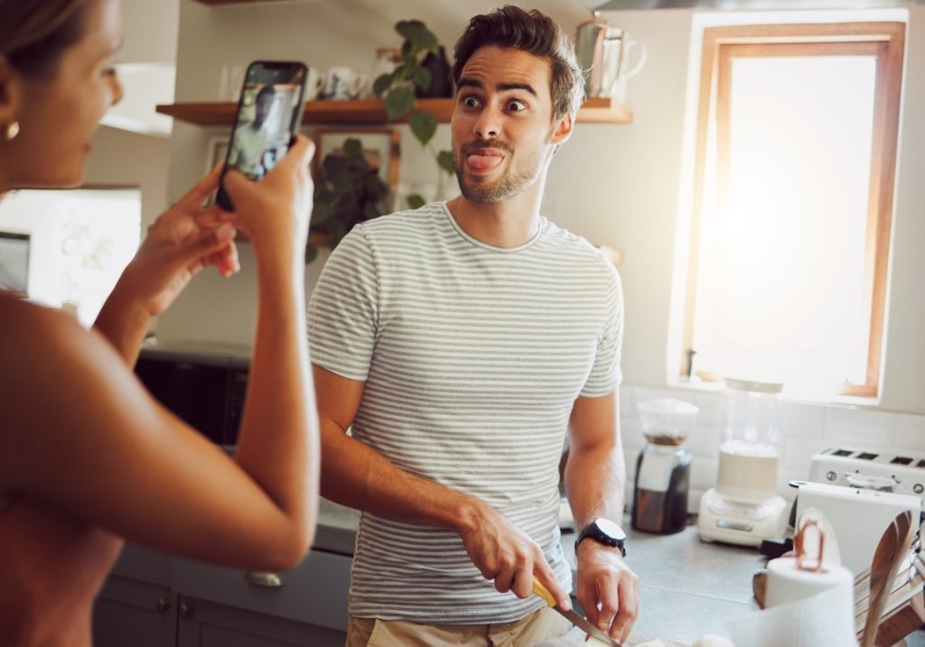 woman taking a picture of her boyfriend