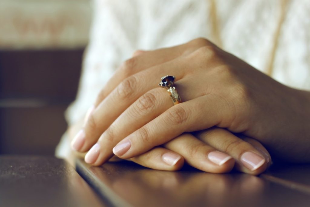 woman wearing a ring with black crystal