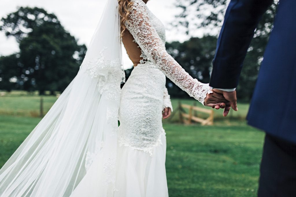 bride and groom holding hands