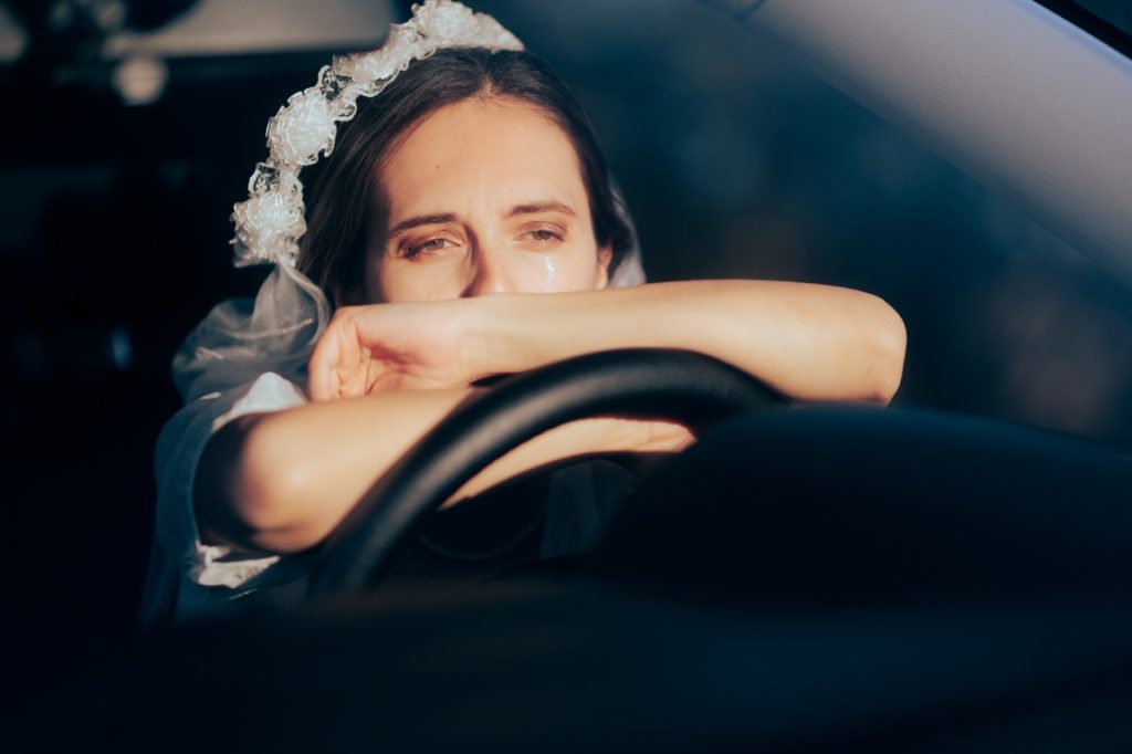 bride crying inside a car