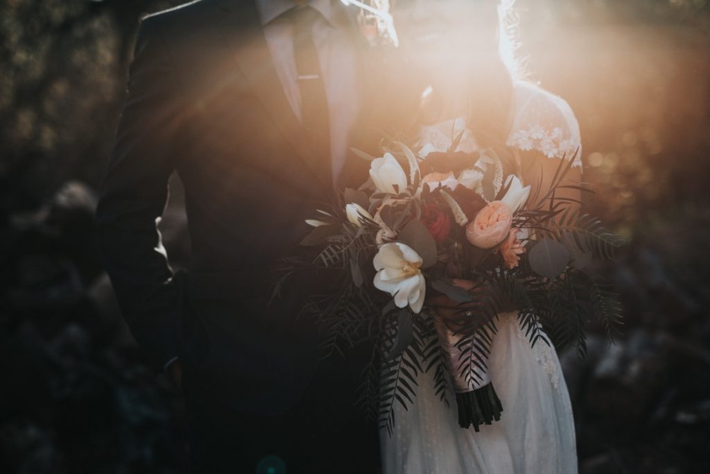 groom and bride holding a bouquet
