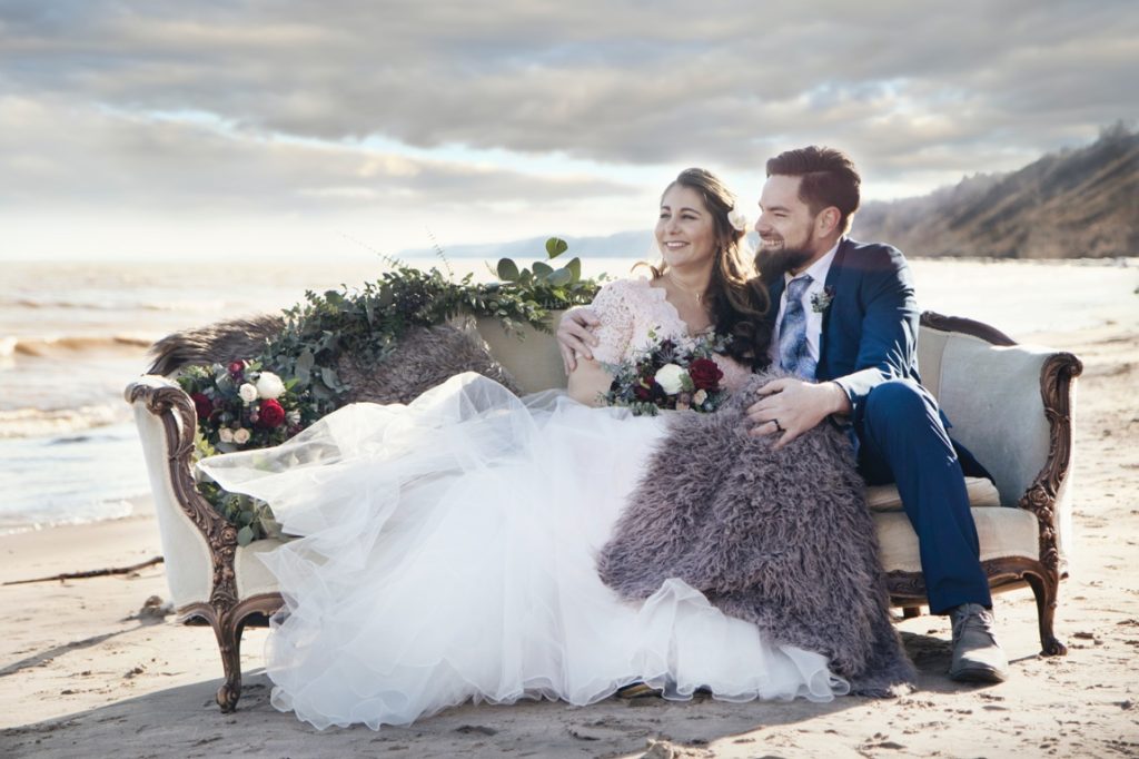 newlyweds sitting on a fancy couch