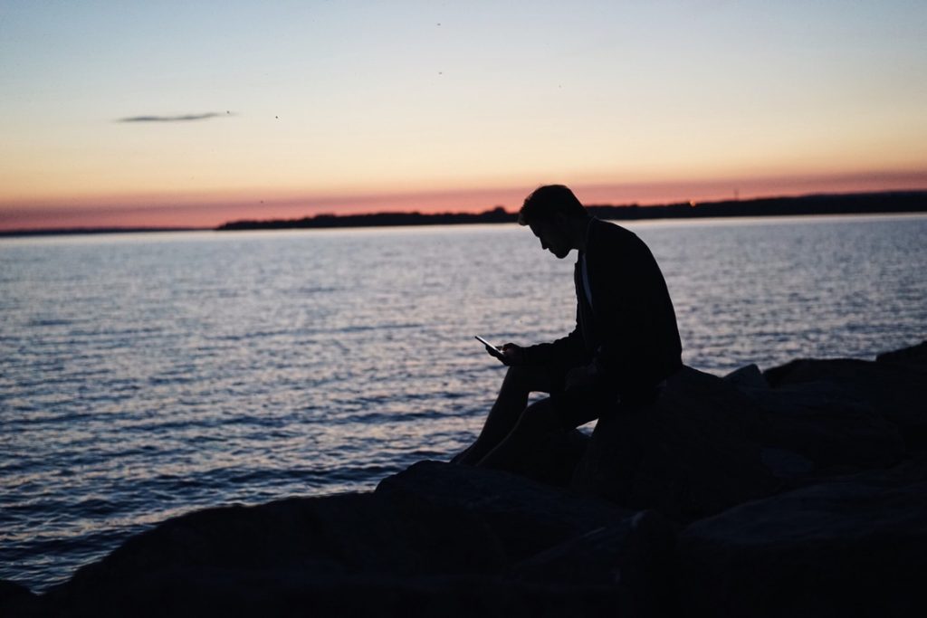 silhoutte of a man using his phone