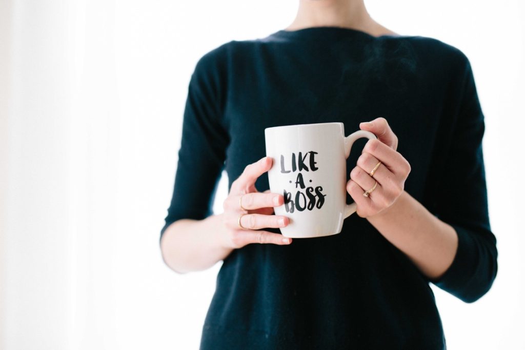 woman holding a like a boss mug