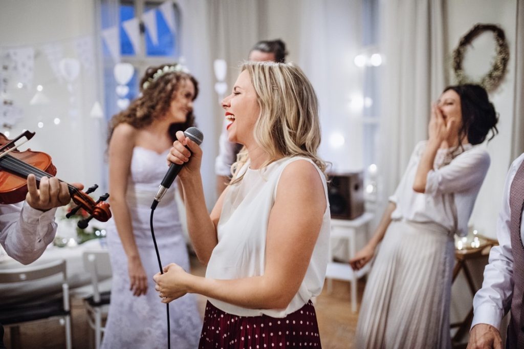 woman holding a mike during reception