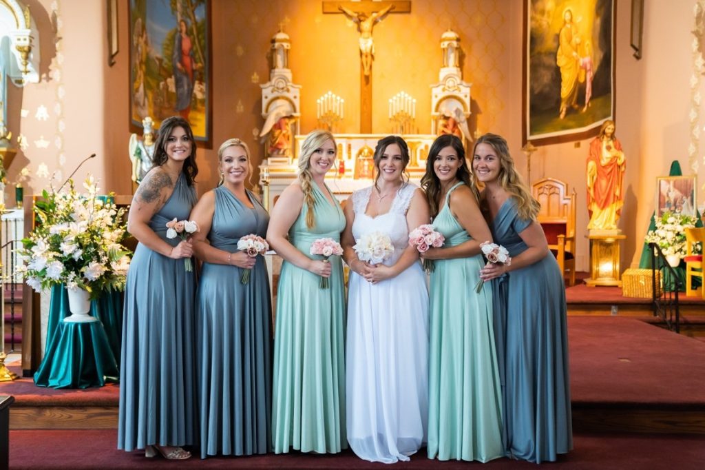 bride and bridesmaids holding a flower bouquet