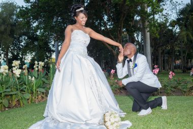 groom kissing bride's hand