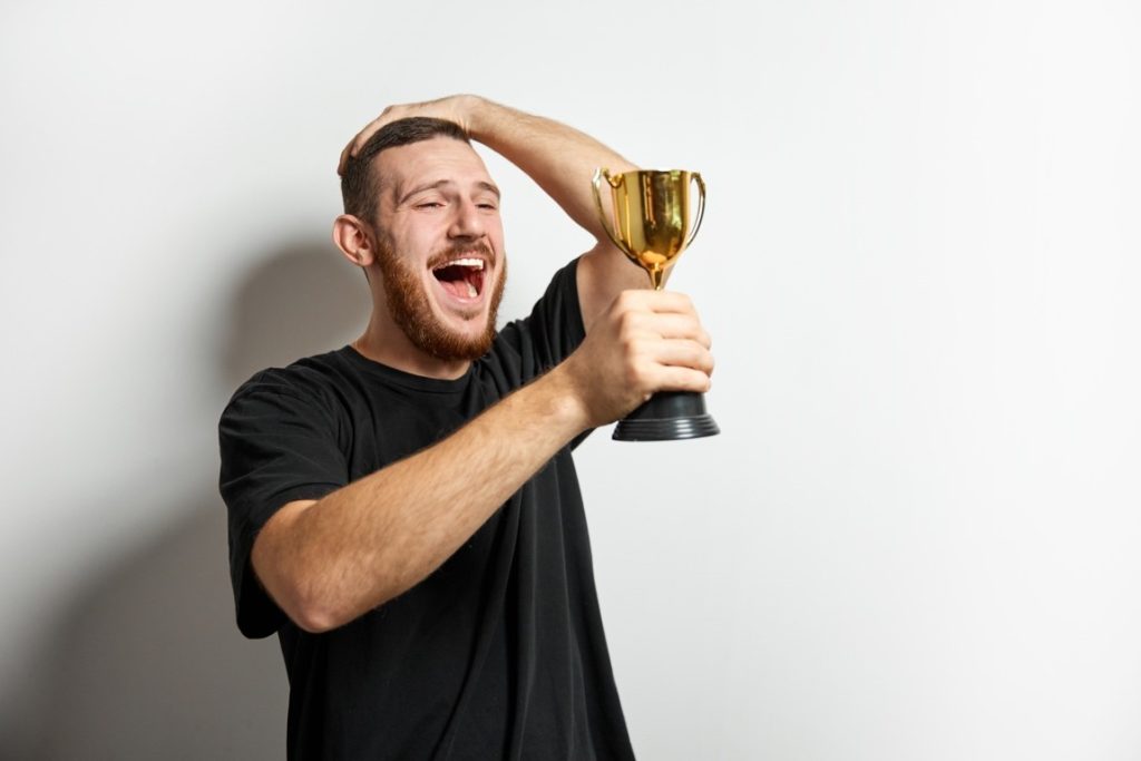 man holding a trophy