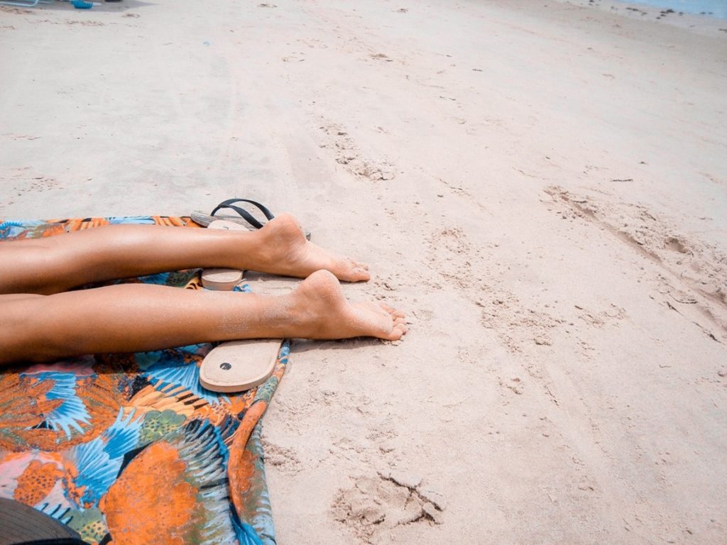 woman's feet on a beach