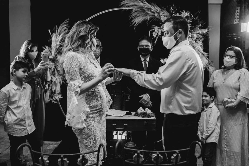 bride putting ring on groom