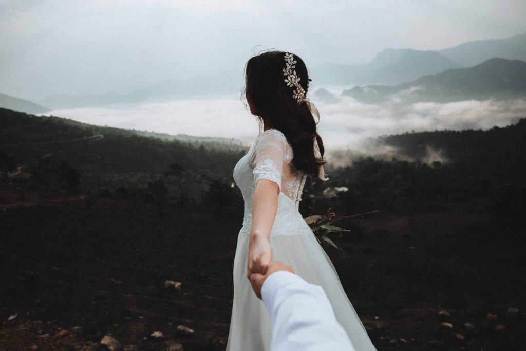 groom holding bride’s hand