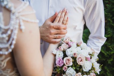 groom holding bride's hand