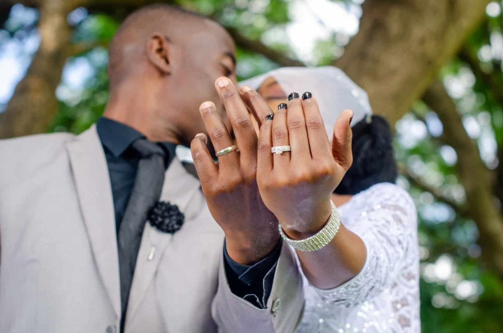 newlyweds showing off their wedding ring