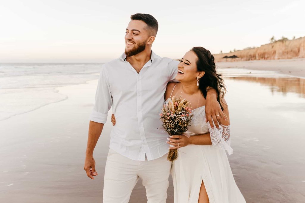 newlyweds walking at the beach