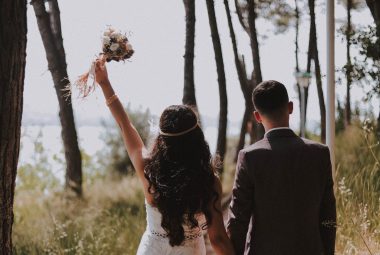 newlyweds walking on paved pathway