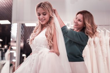 woman putting veil on her daughter