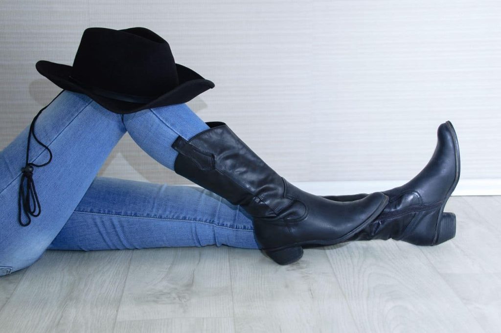 woman with cowboy boots and hat