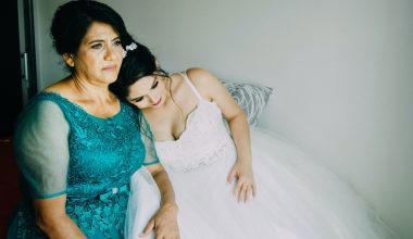 bride lying her head on a woman's shoulder