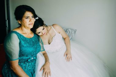 bride lying her head on a woman's shoulder