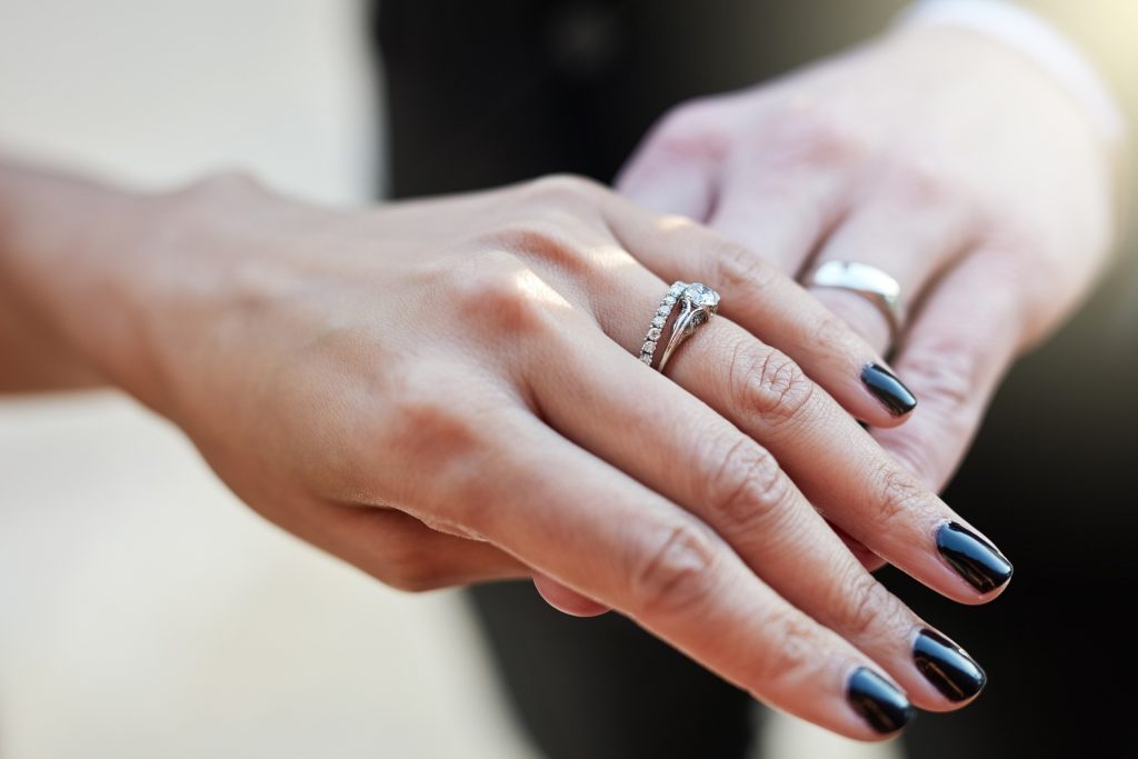 couple's hands with wedding rings