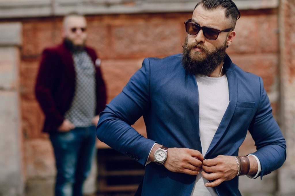 two men wearing blazers with chic accessories