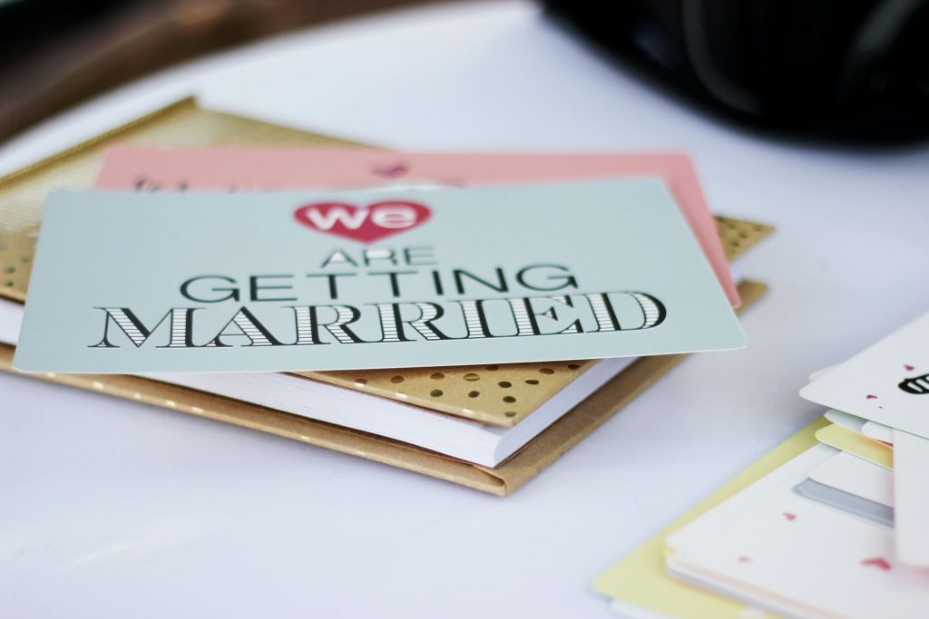 a blue card with text that says 'we are getting married' on top of another card