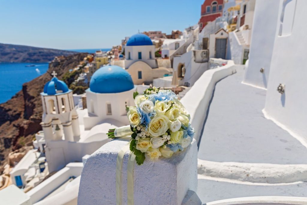 bridal bouquet with the architecture of santorini in the background