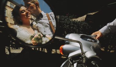 reflection of newlyweds in a bike mirror