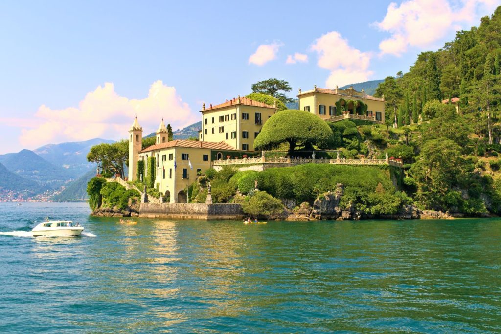 villa del balbianello surrounded by greenery with a view of lake como