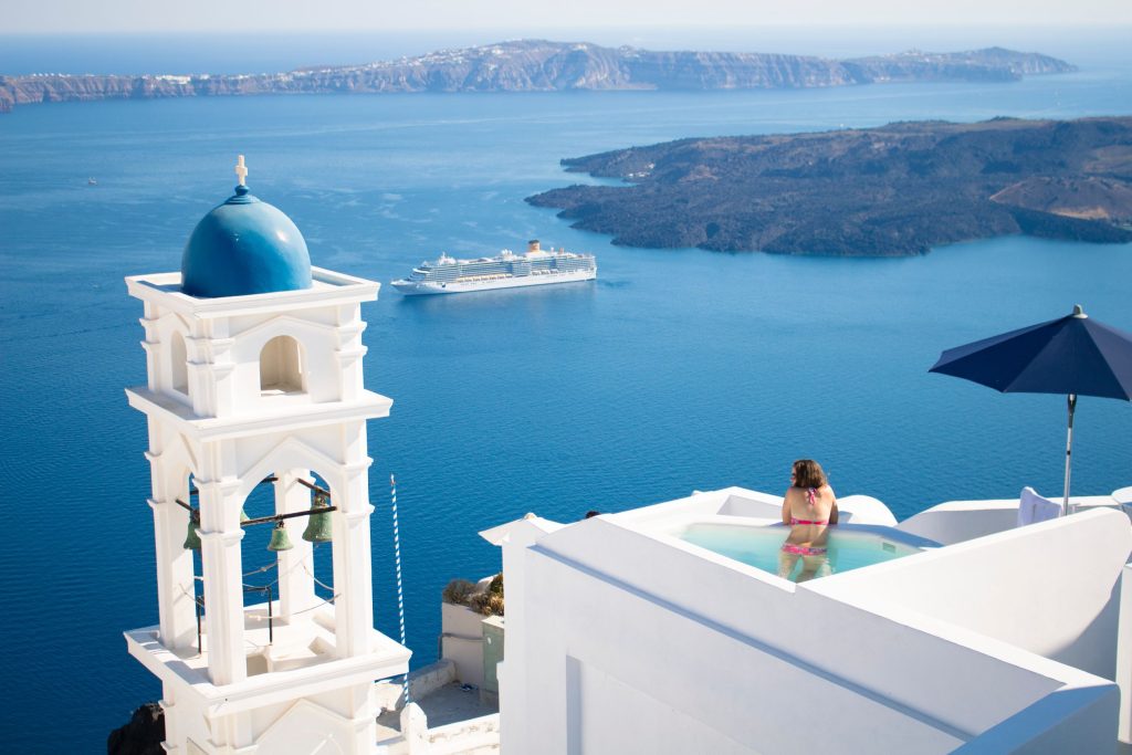 woman in a private pool overlooking the aegean sea