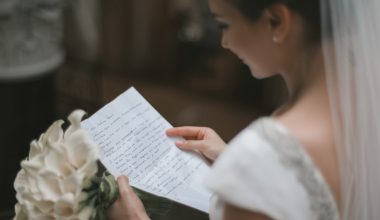 Bride with bouquet and wedding vow in hands