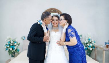 Man and Woman Kissing Woman in White Wedding Dress
