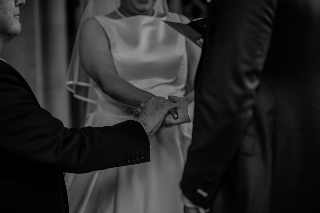 bride and groom holding hands during marriage registry