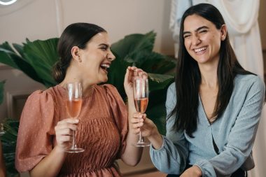 Two Women Having Fun while Drinking a Rosé