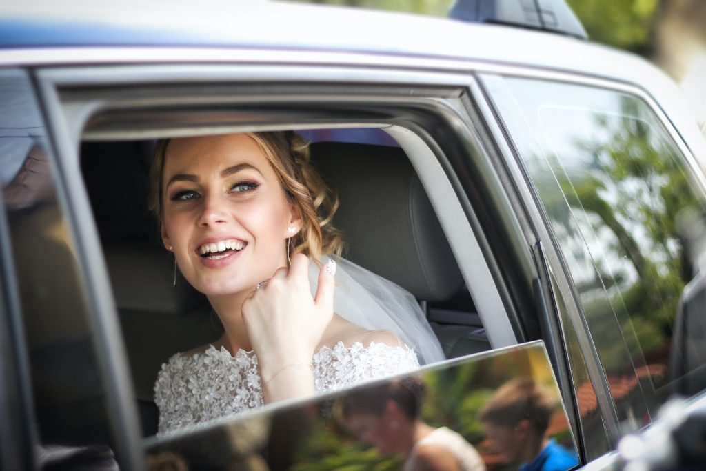bride looking out of bridal car