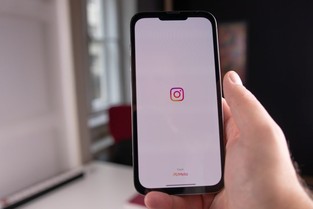 phone flashing the opening screen of instagram